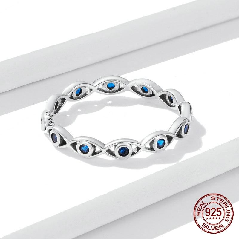 Silver ring with blue gemstones on a white background, featuring a 'Real 925 Sterling Silver' stamp.