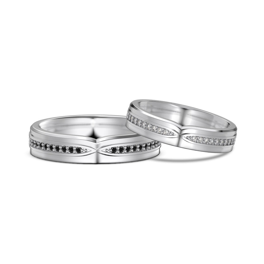 Two silver wedding bands with small gemstones on a white background