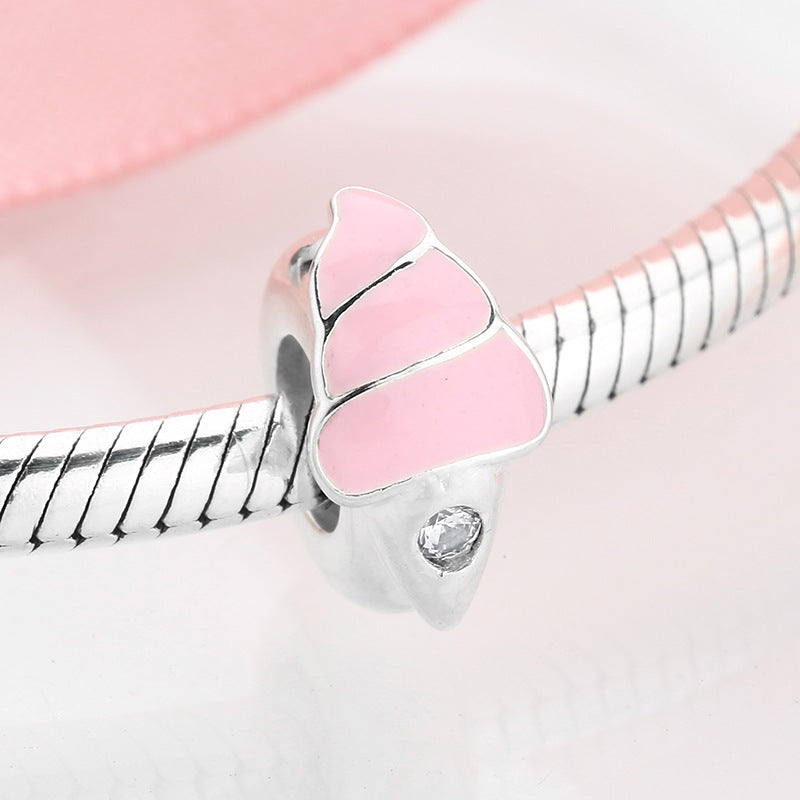 Silver charm with a pink heart-shaped enamel on a pink background