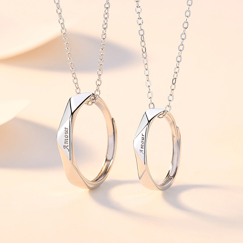 Two silver necklaces with geometric pendants on a soft beige background
