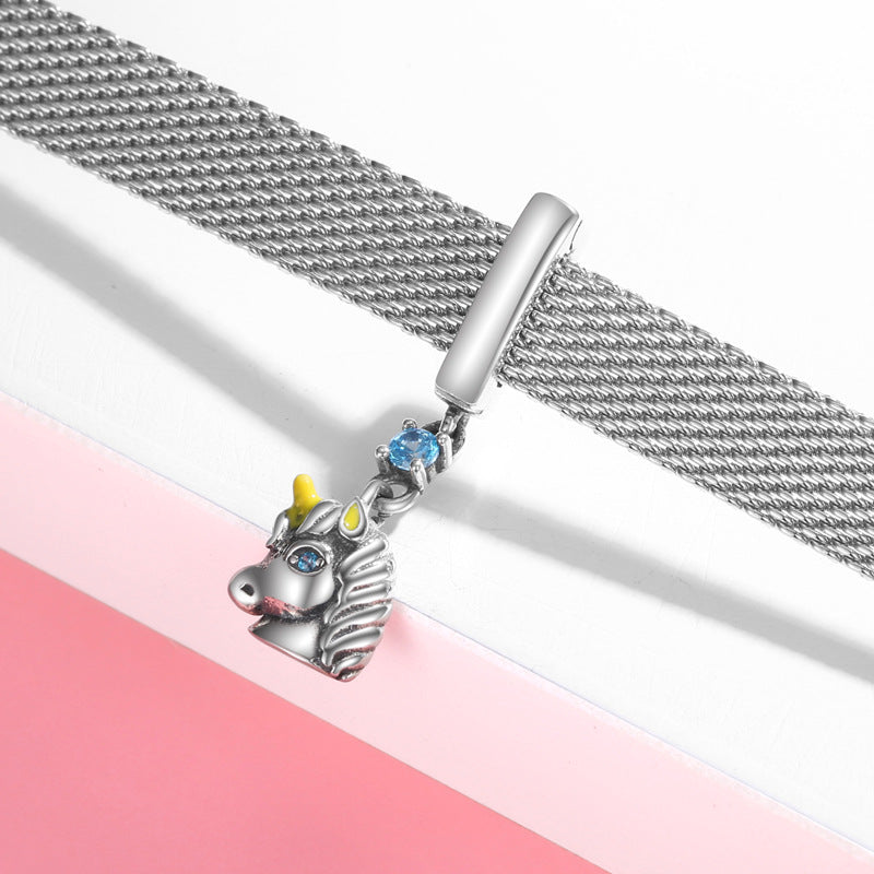 Silver bracelet with a unicorn charm on a pink and white background