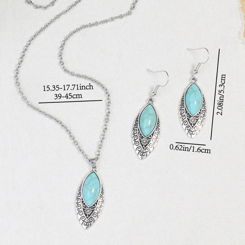 Silver necklace and matching drop earrings with light blue marquise-shaped stones and ornate filigree settings, shown on a white background with measurement labels.
